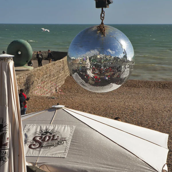 Brighton beach reflected in a mirror ball hanging in one of the beach front cafes — Stock Photo, Image