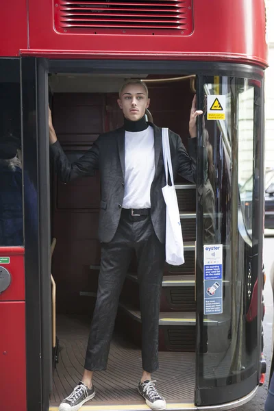 Short-haired blonde man in tight short trousers and a jacket — Stock Photo, Image