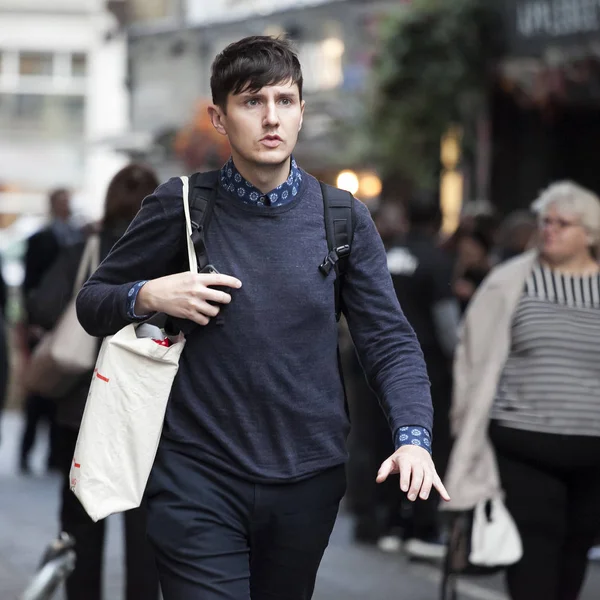 Un bell'uomo indossa maglione e borsa cammina per le strade di Londra — Foto Stock