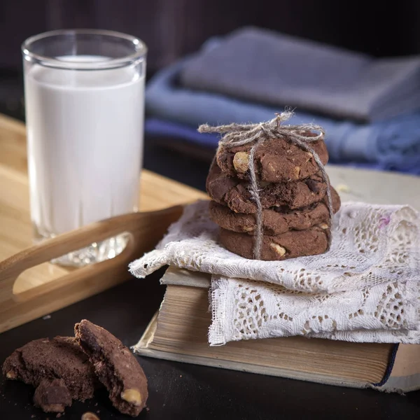 the dark chocolate biscuits with nuts on dark wooden background