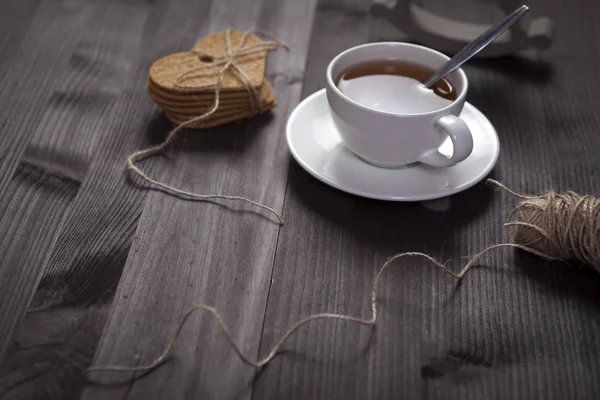 Den vita koppen te och tefat på ett brunt träbord. Kopiera utrymme — Stockfoto