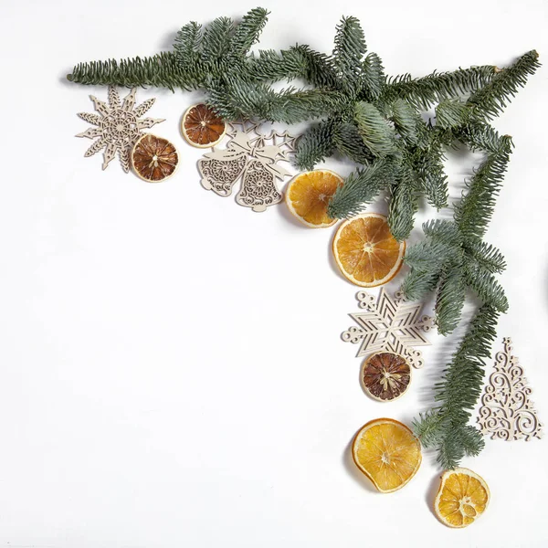 Takken van een kerstboom met droge sinaasappelen en New Year's speelgoed. Kerstkaart — Stockfoto