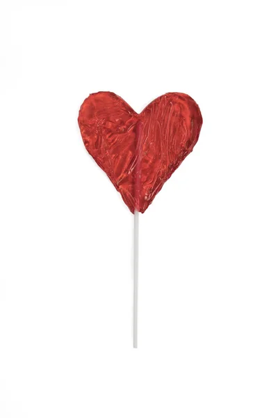 El caramelo rojo de la piruleta en forma de corazón enfondo blanco . —  Fotos de Stock