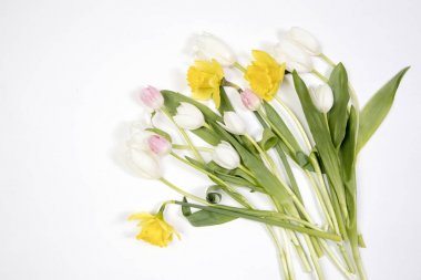 Sarı lastik çizme bir buket çiçek sarı nergis ve beyaz ve Pembe Lale ile. Bahçe aksesuarları.