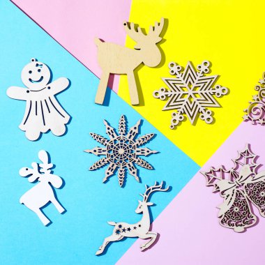 Pembe, mavi, sarı kağıdın üzerinde duran güzel bir Noel süslemesinin yüksek açılı yakın plan fotoğrafı.