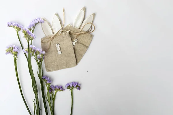 Förpackning duk presentpåsar med knappar i form av en hare på en vit bakgrund. — Stockfoto