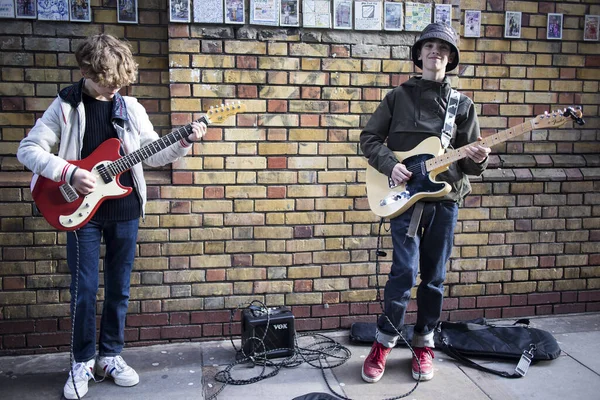 Nastolatki grają na gitarach podczas tradycyjnego niedzielnego pchlego targu na Brick Lane — Zdjęcie stockowe