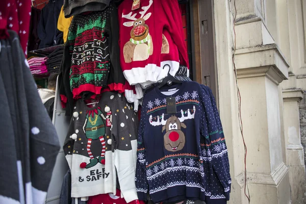 A temporary seasonal display of ugly Christmas sweaters at a retail store . — Stock Photo, Image