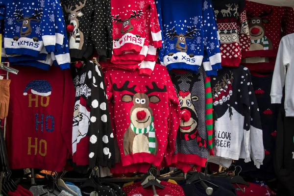 A temporary seasonal display of ugly Christmas sweaters at a retail store . — Stockfoto