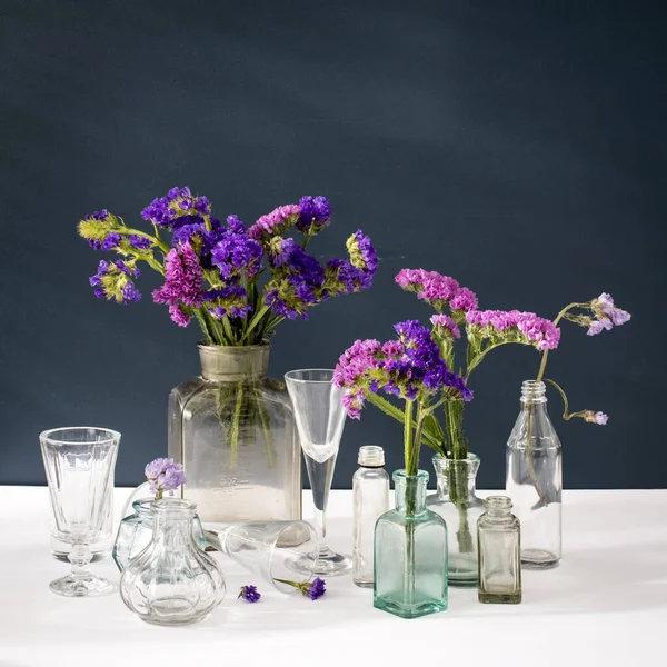 Bouquet Limonium Transparent Vase Set Small Bottles Dark Blue Background — Stock Photo, Image