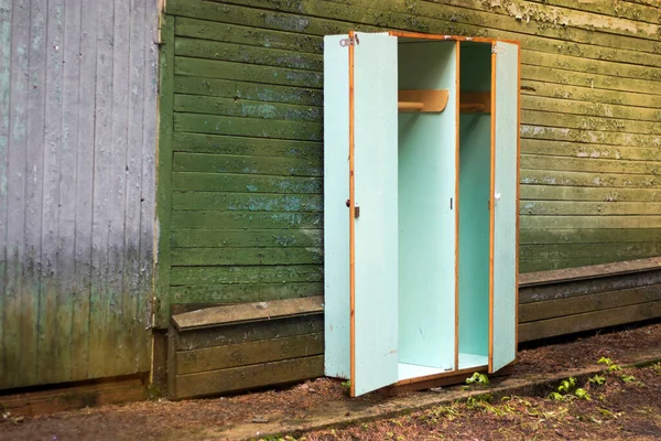 Old closet in an abandoned Russian pioneer camp in the forest. Space for text