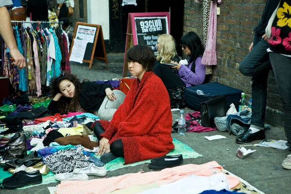 英国伦敦 2019年8月20日 一位年轻的时尚女友坐在Bricklane街头跳蚤市场的人行道上出售她们的旧物 — 图库照片