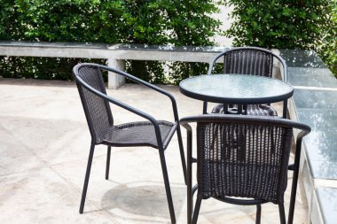 Çizgili masa ve hasır koltuklar. Açık havada.