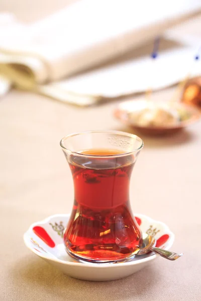 Cup of turkish tea with locum on oriental plate. Concept of turk