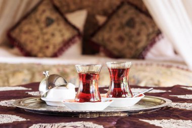 Two turkish tea cups and turkish delight with oriental canopy be clipart
