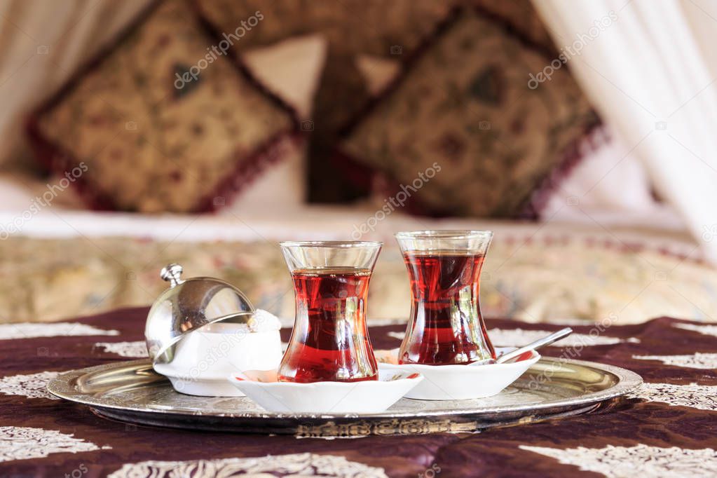 Two turkish tea cups and turkish delight with oriental canopy be