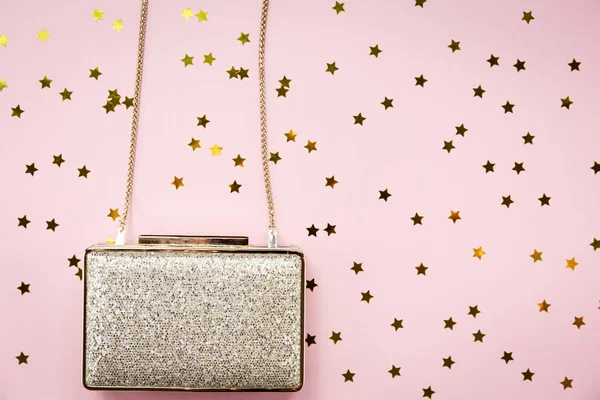 Festive evening golden clutch with star sprinkles on pink. Holid