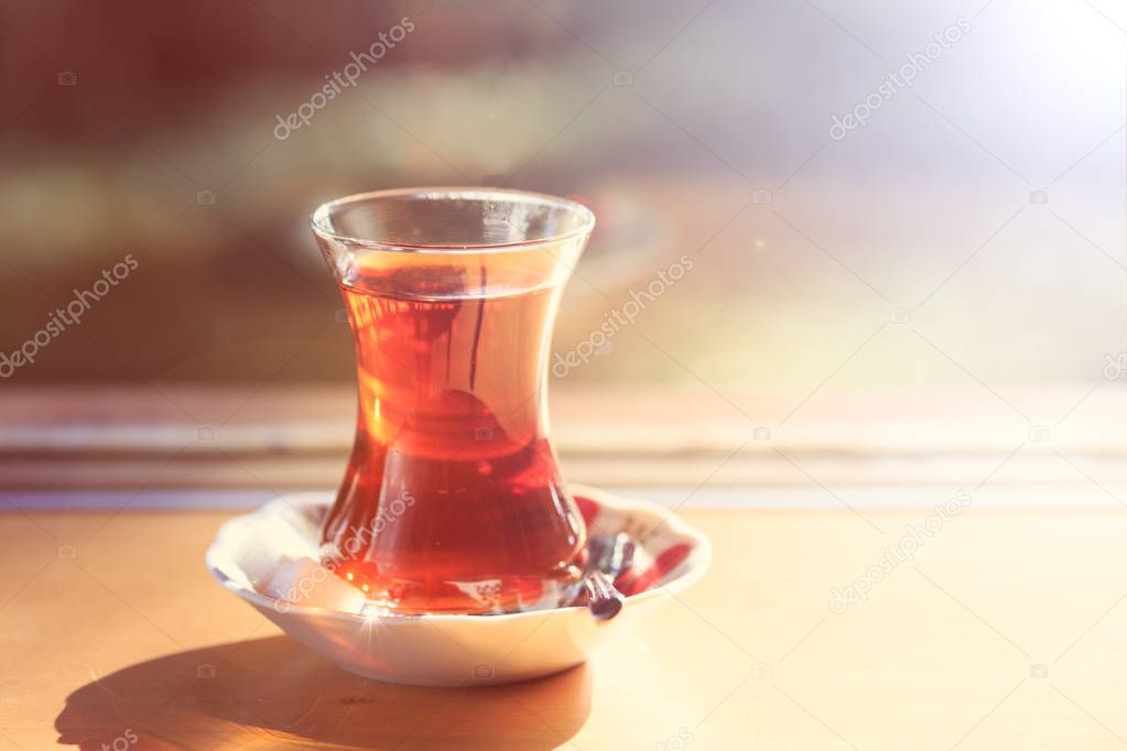 Hot turkish tea outdoors near glass wall. Turkish tea and tradit