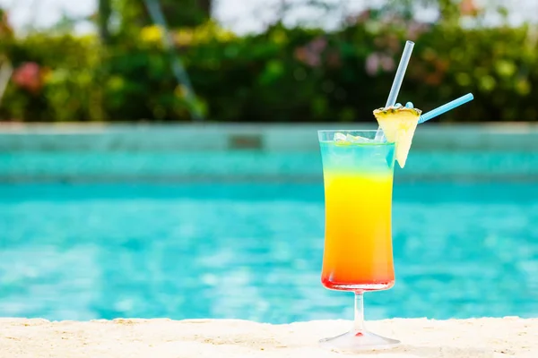 Cóctel arco iris en el borde de una piscina del complejo. Concepto de lujo —  Fotos de Stock