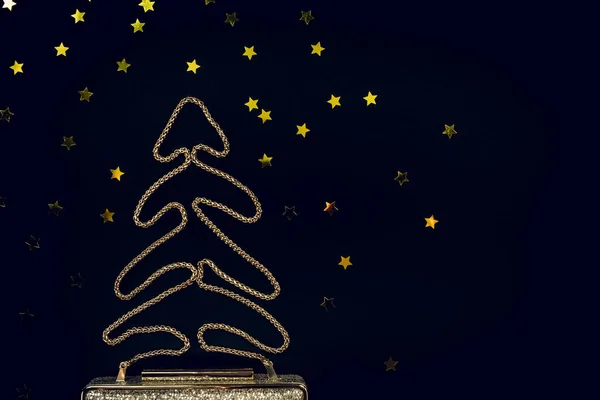Festive evening golden clutch with star sprinkles on black. Holi — Stock Photo, Image