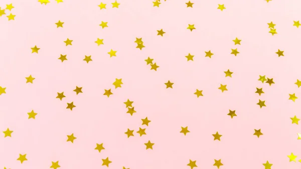 A estrela dourada polvilha no rosa. Fundo festivo de férias. Celeb. — Fotografia de Stock