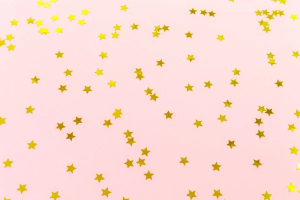 金色的星洒在粉红色。节日背景。名人 — 图库照片