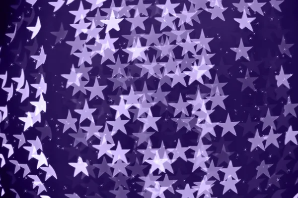 Fondo bokeh borroso en forma de estrella con destellos. Ultra violeta — Foto de Stock