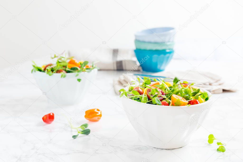 Mixed baby greens and cherry tomatoes salad in bowl. Superfood s