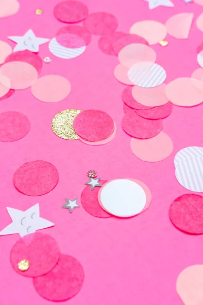 Multicolor pink, gold and white confetti on the bold pink background, holiday celebration backdrop