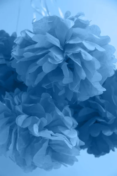 Paper flowers at the party. Party celebration concept in blue shade