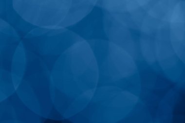 Bokeh ışıkları olan tek renkli klasik mavi arka plan. Tatil, Noel ve Yeni Yıl geçmişi