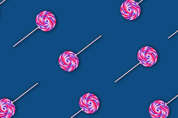 Pattern of giant pink lollipops on solid classic blue background — Stock Photo, Image