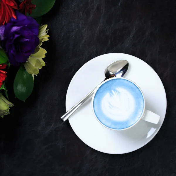 Copa de café con leche azul vegano en la gota oscura. Concepto de café de moda libre de descanso de refresco vegano — Foto de Stock