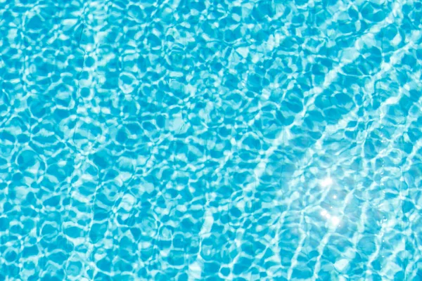 Oppervlakte van blauw glanzend zwembad water rimpel en zon reflectie — Stockfoto