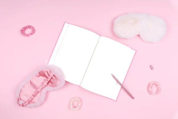 Journal with cute fluffy sleep masks and pink accessories