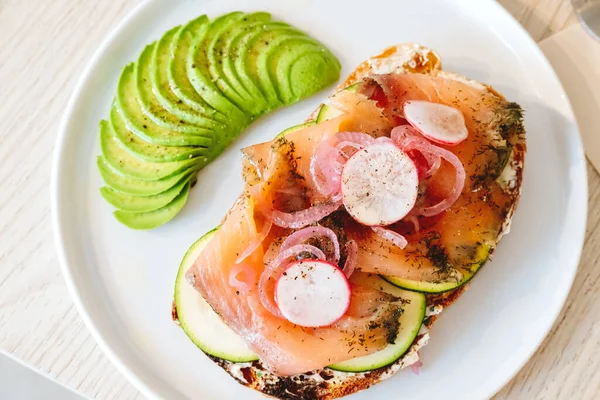 Salmon toast with avocado and vegs in the modern cafe — Stock Photo, Image