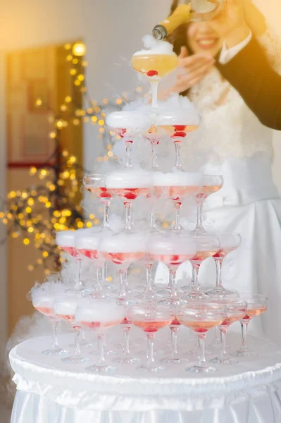 A pyramid of champagne glasses with a cherry — Stock Photo, Image