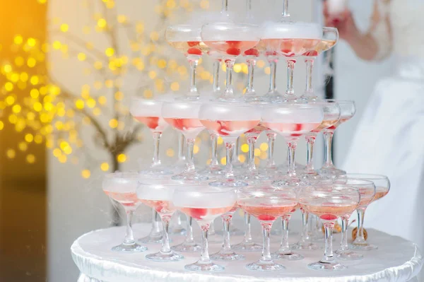 A pyramid of champagne glasses with a cherry — Stock Photo, Image