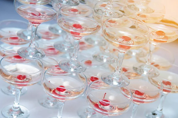 A pyramid of champagne glasses with a cherry — Stock Photo, Image