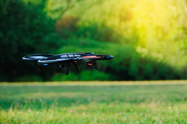 Outdoor flying drone. Quadrocopter in park — Stock Photo, Image