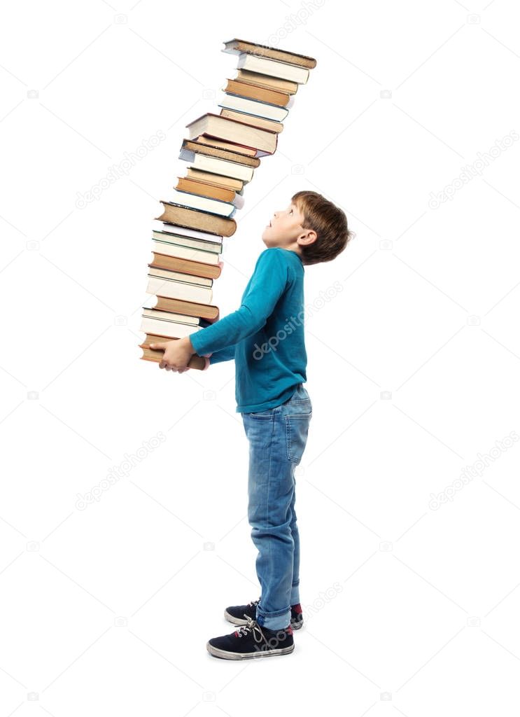 Small Child in Primary School age carrying a very high stack of Books