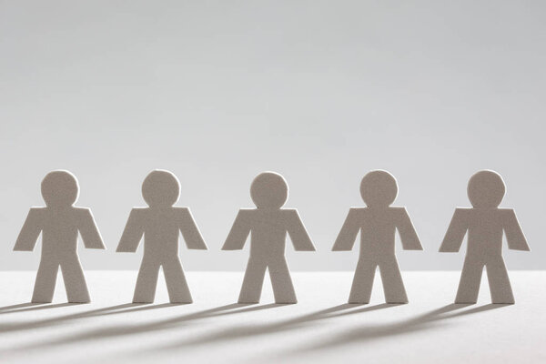 Little People, Simply Team, Grey people in a row on Grey Backgro
