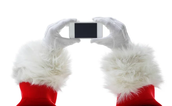 Weihnachts-Konzeptaufnahme mit dem Weihnachtsmann, der ein weißes Smartphone in der Hand hält — Stockfoto