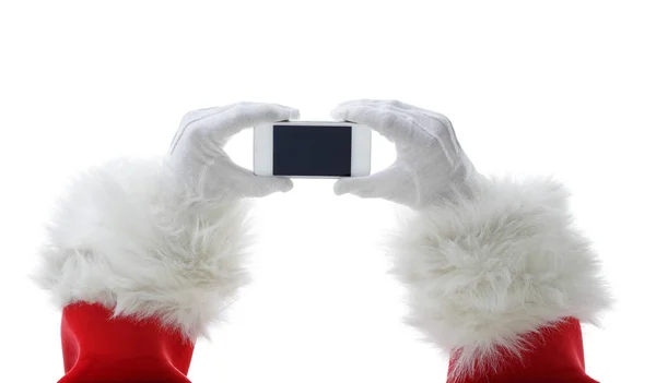 Jul-konceptet sköt med Santa hålla en vit smart telefon isolerade på vit — Stockfoto