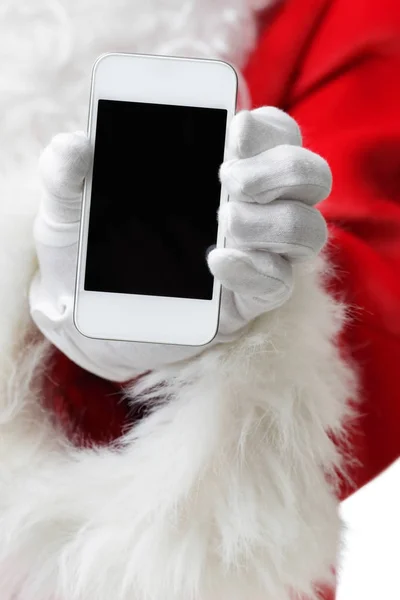 Weihnachts-Konzeptaufnahme mit dem Weihnachtsmann, der ein weißes Smartphone in der Hand hält — Stockfoto