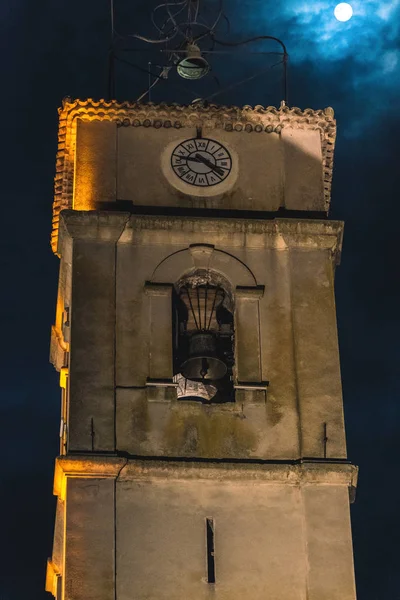 The medieval church tower at night during a full moon