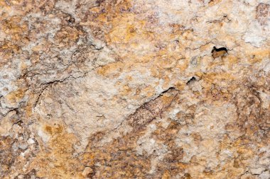 A grunge texture background of an old stone relief wall