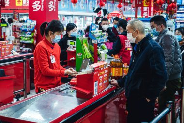 CHINA,WUHAN,Wuchang1 Zhongbei Rd.,supermarket Carrefour.-JANUARY 27,2020: Coronavirus epidemic in China .People wearing face masks.