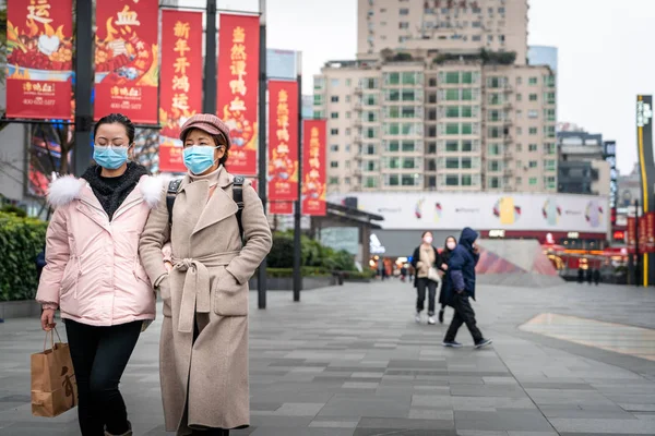 CHINA,CHENGDU,Chunxi Rd.-JANUARY 23,2020: Coronavirus epidemic in China .People wearing face masks.