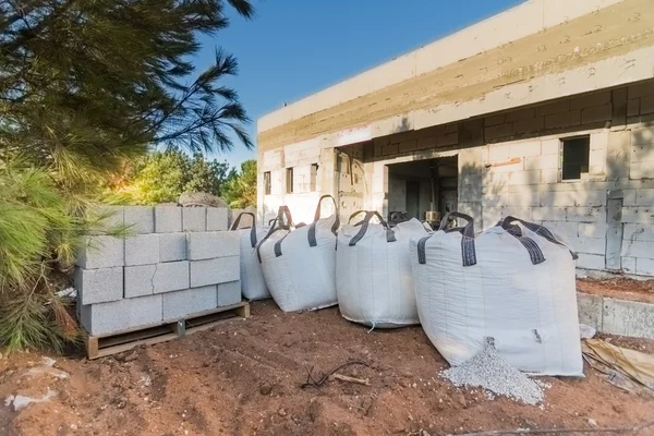 Bricks and bags of gravel in a construction site